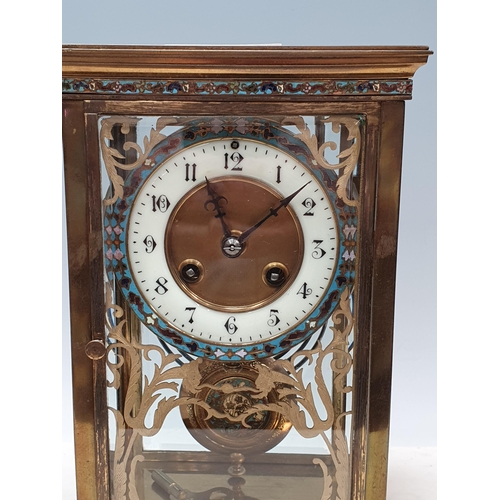 549 - A brass and champleve Mantel Clock with circular dial marked with Arabic numerals, the inside of the... 