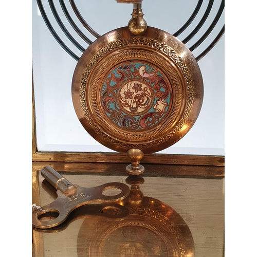 549 - A brass and champleve Mantel Clock with circular dial marked with Arabic numerals, the inside of the... 