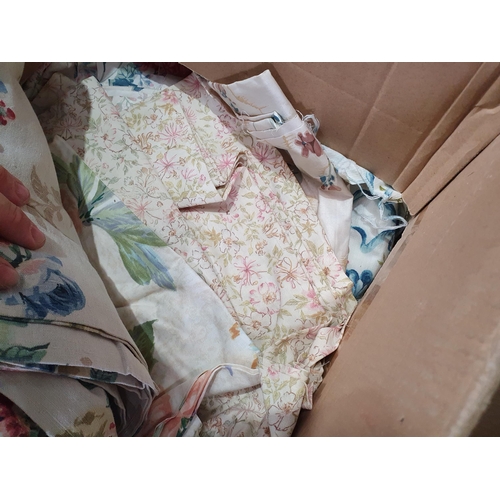 555 - Two Boxes of assorted Textiles including, Cushions, Linen, Curtains, etc. (R6).