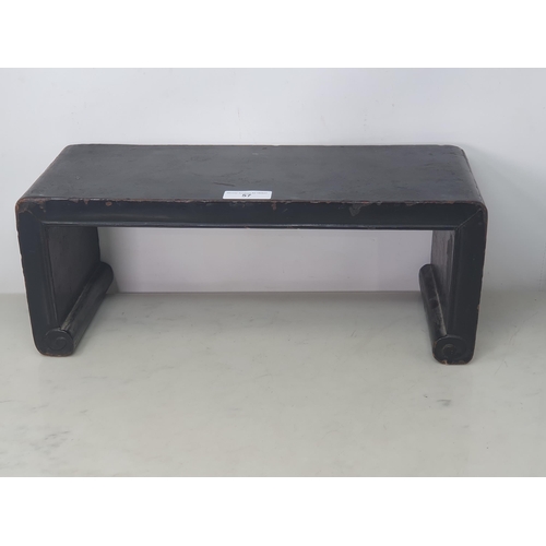 57 - A Chinese black lacquered Stand with shaped supports, 18 x 7in (R3)