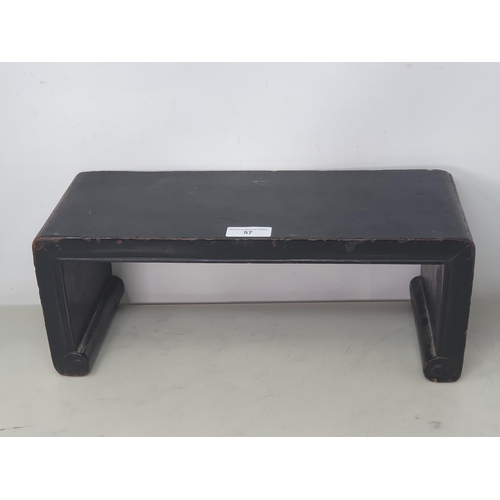 57 - A Chinese black lacquered Stand with shaped supports, 18 x 7in (R3)