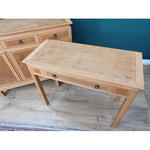 605 - A modern oak veneered Sideboard fitted three frieze drawers above three cupboard doors marked 'Wade'... 