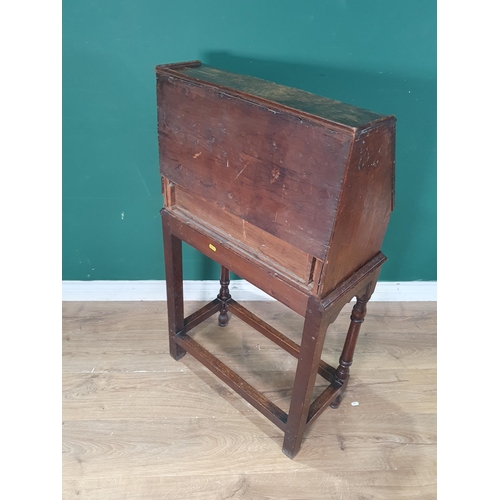 624 - An antique oak Bureau on stand with fall front enclosing drawers and pigeon holes above drawer raise... 