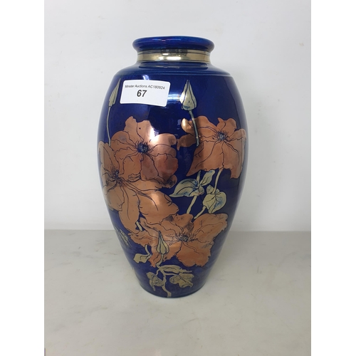 67 - A JCJ pottery lustre Vase of ovoid form with floral design on a blue ground, 11in,marked under with ... 