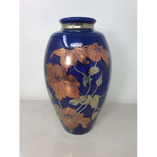 67 - A JCJ pottery lustre Vase of ovoid form with floral design on a blue ground, 11in,marked under with ... 