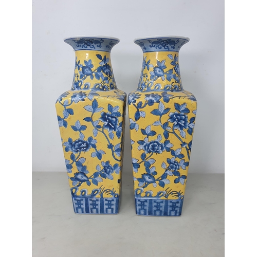 68 - A pair of Chinese square section Vases with blue floral design on a yellow ground, 14in (R2)