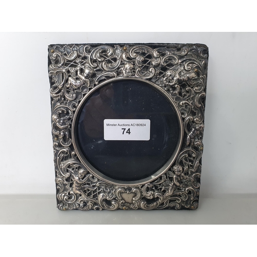 74 - An Edward VII silver square Photograph Frame embossed and pierced with cherubs and scrolls, London 1... 