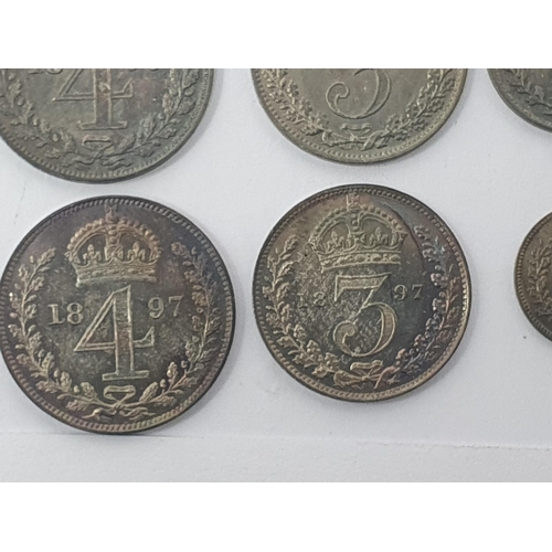 77 - A Victoria silver Jubilee Medal and four Maundy Coins, 1897, three other Sets of Maundy Coins 1899 &... 