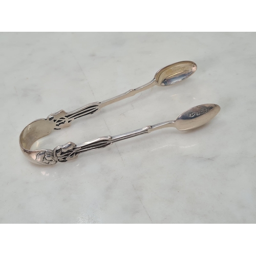 89 - Five Edward VII Art Nouveau silver Teaspoons and Sugar Tongs with ornate finials, Sheffield 1905, in... 