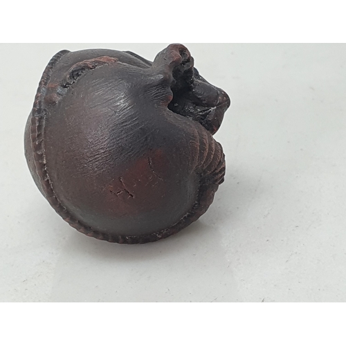 97 - A carved Netsuke in the form of a coiled rat, bears signature