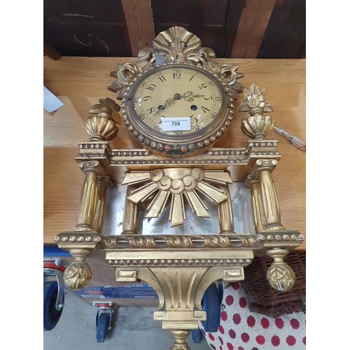 708 - A Continental gilt framed Wall Clock with circular dial, two train movement, the case with mirror pa... 