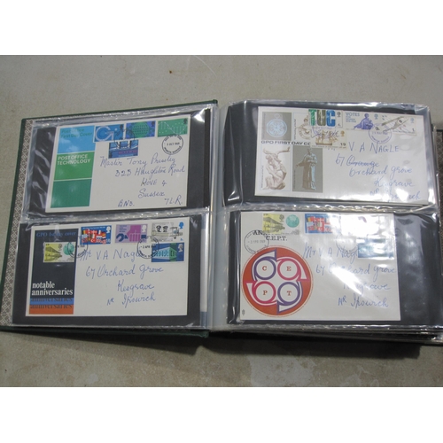 403A - An album containing approx 150 GB QE11 First day Covers; and some mint stamps in packs (qty)