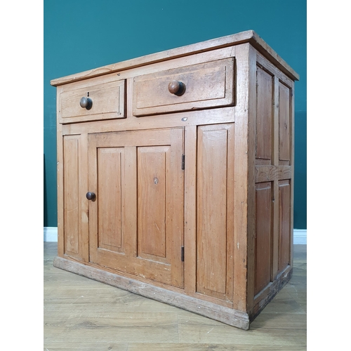 579 - A pine Cupboard fitted two drawers above central solid panelled door, 3ft 5in wide, 3ft 1in high,