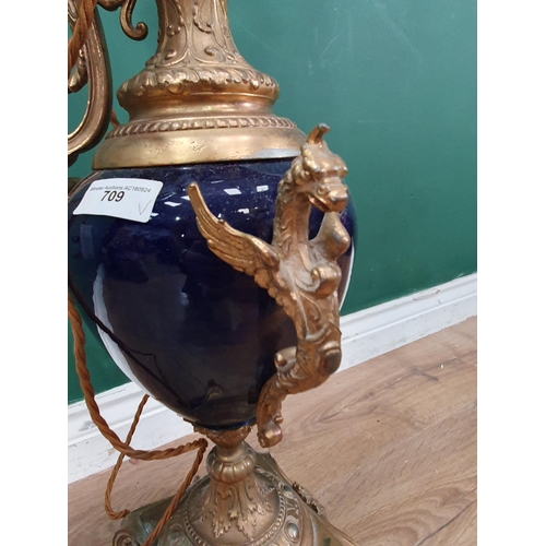 150 - A large Lamp in the form of a gilt-metal and blue ceramic ewer, on square base with scroll and paw f... 