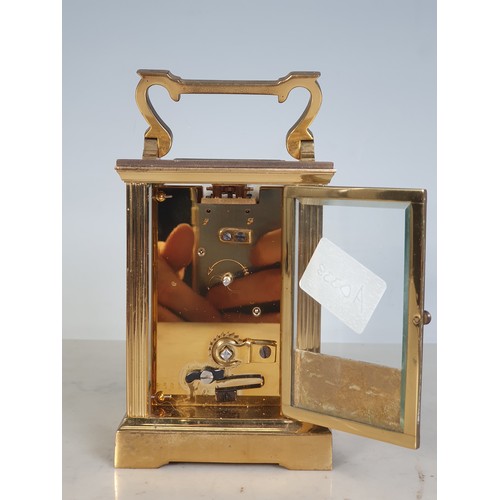 75 - A brass cased Carriage Clock by Mappin & Webb with applied brass inscription plate to the back, 4 1/... 