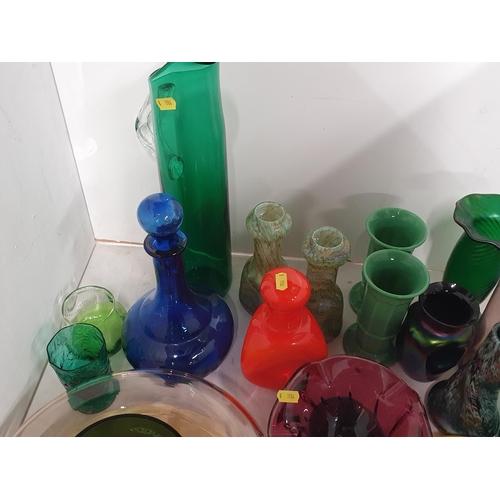 133 - A quantity of coloured glass including two overlaid Vases, green and amethyst Beakers, a tall green ... 