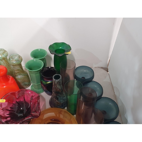 133 - A quantity of coloured glass including two overlaid Vases, green and amethyst Beakers, a tall green ... 