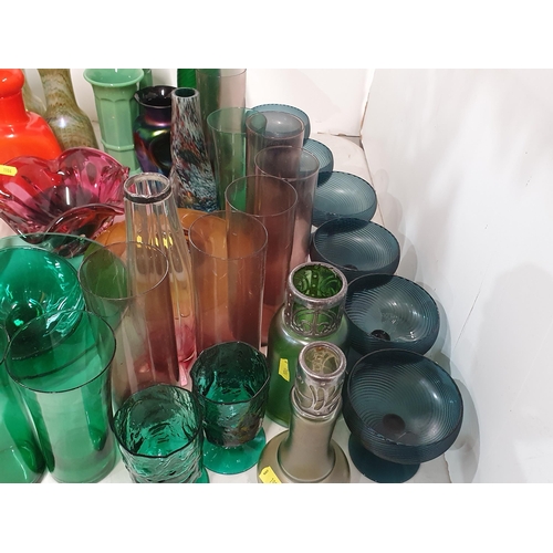 133 - A quantity of coloured glass including two overlaid Vases, green and amethyst Beakers, a tall green ... 