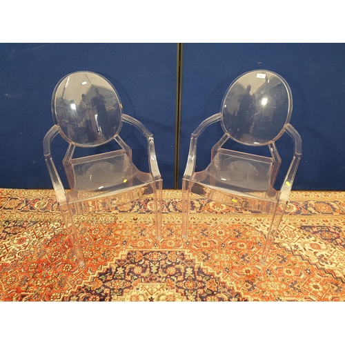 16 - A pair of clear Perspex Elbow Chairs