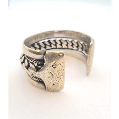 163 - An Egyptian silver rigid rope twist Bangle, approx 130gms