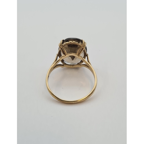 179 - A Smoky Quartz Dress Ring in 9ct gold, ring size O 1/2, approx 3.20gms