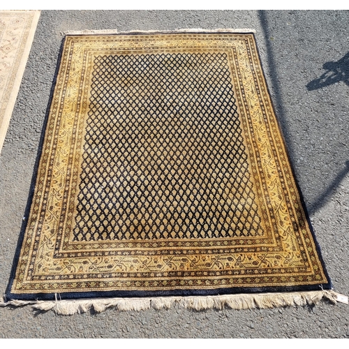 25 - A Mustard ground rug with multi-borders with central lattice work design