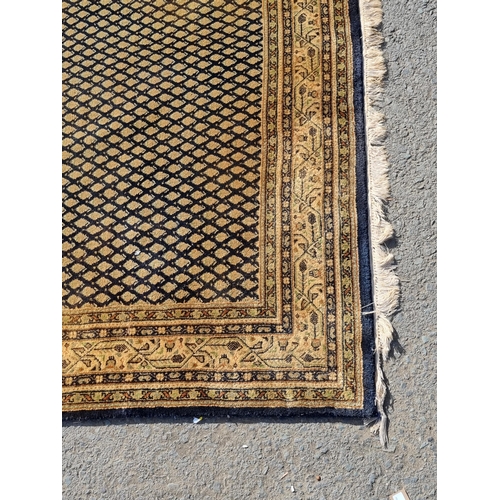 25 - A Mustard ground rug with multi-borders with central lattice work design