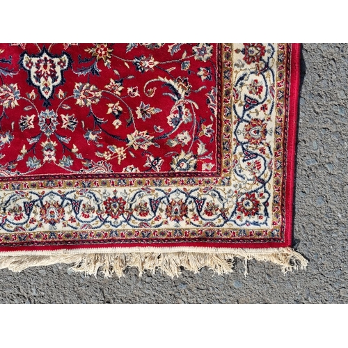 26 - A Red Multi-bordered Ground rug with central floral lozenge