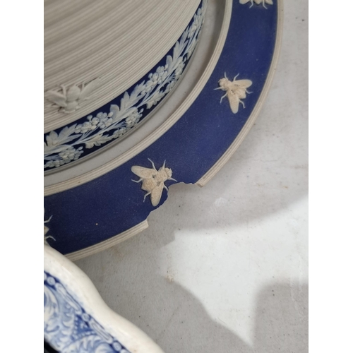 269 - A large blue Jasperware Cheese Dish and Cover with fine relief moulded floral friezes and applied mo... 