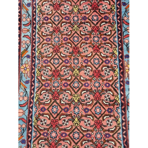 27 - A small Red Ground runner with multi-bordered leafage designs, 200 x 77cms