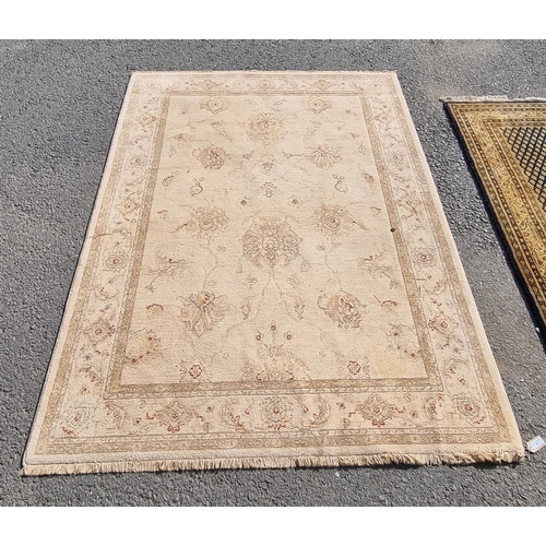 28 - A cream ground rug with multi borders and all over floral motifs, 171 x 237cms