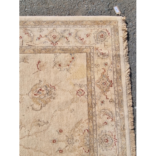 28 - A cream ground rug with multi borders and all over floral motifs, 171 x 237cms