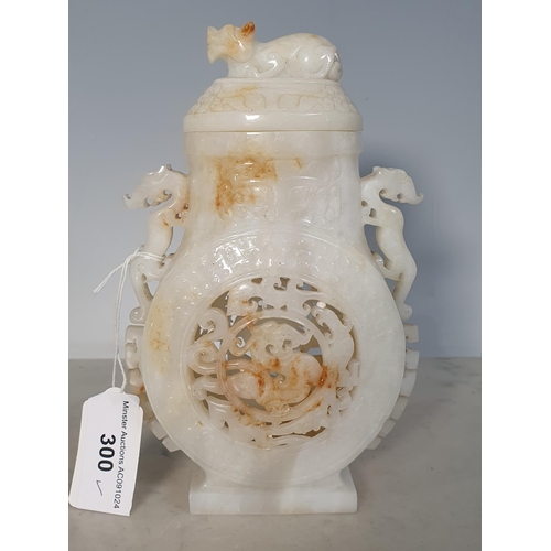 300 - A Chinese white jade Vase and Cover with dog finial, stylised animal handles and piercing to the sid... 