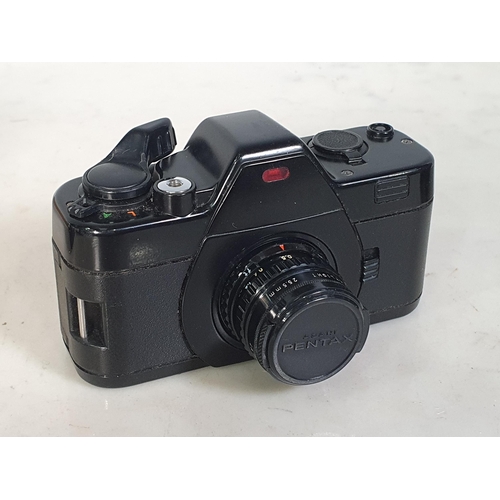 304 - A Pentax AX - 110 Skylight Camera, with lenses and accessories, contained in wooden carry/travel cas... 