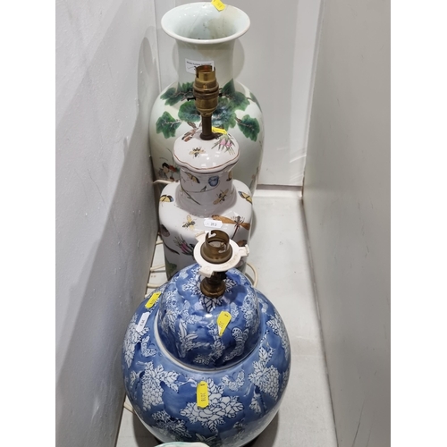 313 - A floral moulded Jug with bird handle, 12in H, two porcelain Table Lamps and a Chinese baluster Vase... 