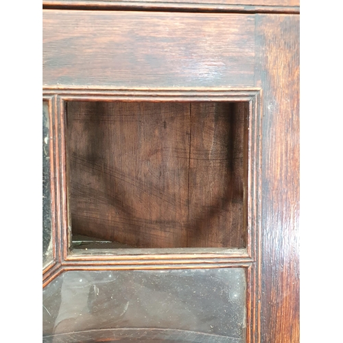 37 - A 19th Century oak and astragal glazed standing Corner Cabinet fitted glazed upper section above bas... 