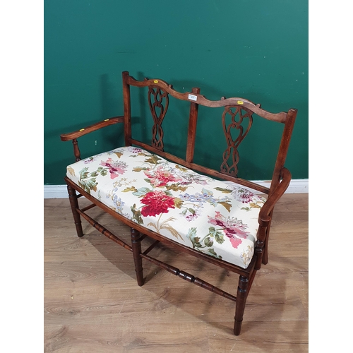 412 - A Victorian mahogany Salon Settee with cream floral upholstery raised on turned supports 3ft 8in W x... 