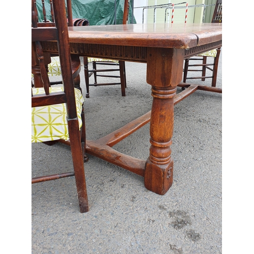 429 - An oak Refectory Table raised on thick turned supports united by central stretcher 7ft L x 2ft 6in H... 