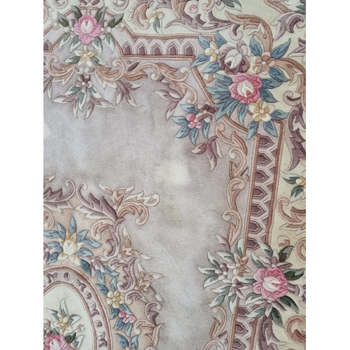 434 - A modern Chinese Rug on cream ground with floral borders, and oval central leafage and floral lozeng... 