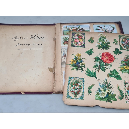 445 - A Victorian Scrap Album containing an extensive collection of cards and pictures A/F (Cab)