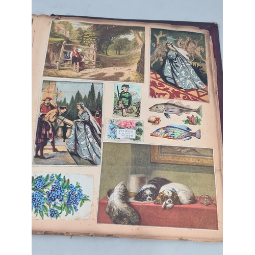 445 - A Victorian Scrap Album containing an extensive collection of cards and pictures A/F (Cab)