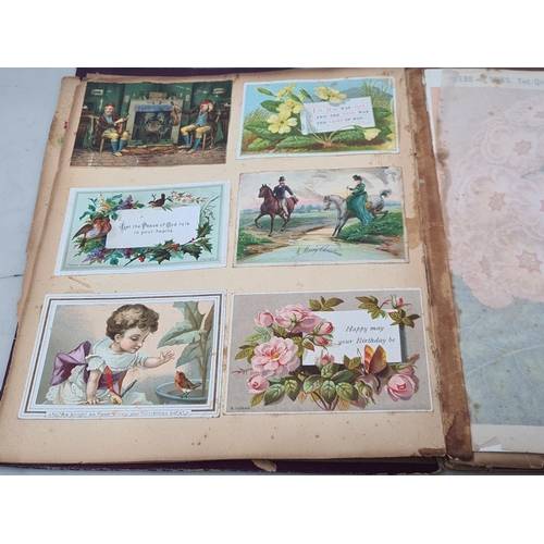 445 - A Victorian Scrap Album containing an extensive collection of cards and pictures A/F (Cab)