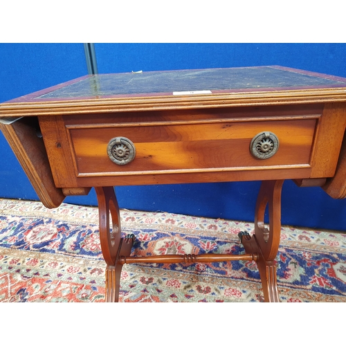 9 - A pair of reproduction yew Dropleaf Sofa Tables with inset leather type surfaces above single fitted... 