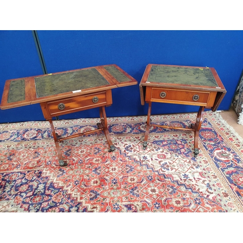 9 - A pair of reproduction yew Dropleaf Sofa Tables with inset leather type surfaces above single fitted... 