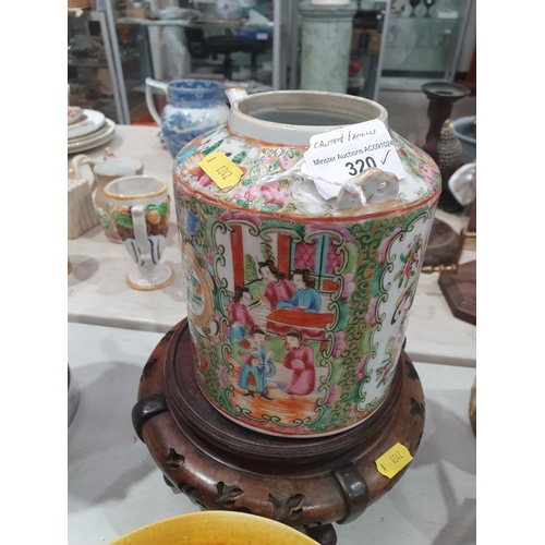 320 - A Cantonese Kettle lacking handle, decorated panels of figures and flowers on associated wooden stan... 