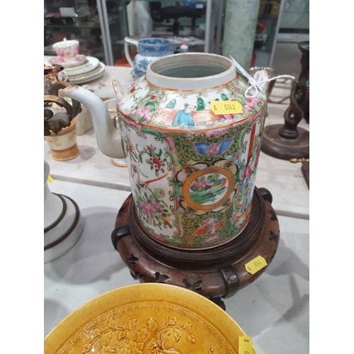 320 - A Cantonese Kettle lacking handle, decorated panels of figures and flowers on associated wooden stan... 