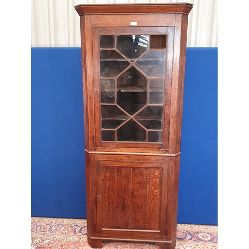 662 - A 19th Century oak and astragal glazed standing Corner Cabinet fitted glazed upper section above bas... 