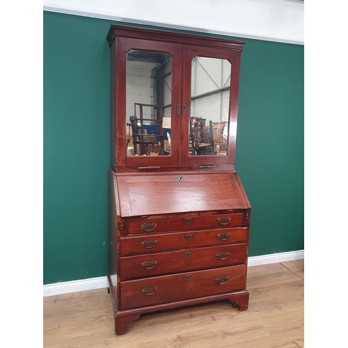 790 - A Georgian mahogany Bureau Bookcase, the upper section with mirror panelled doors, enclosing adjusta... 