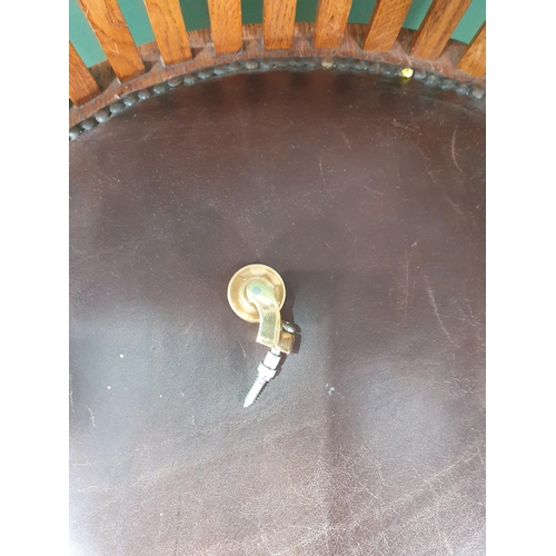 An oak framed Swivel Chair with leather style upholstered seat, raised