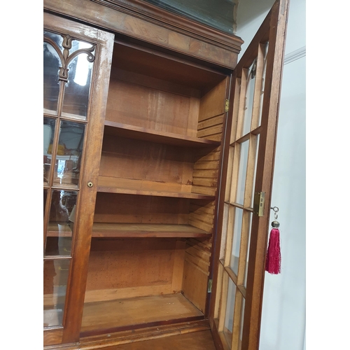 788 - A 19th Century mahogany Secretaire Bookcase, the upper section with pair of glazed doors enclosing t... 